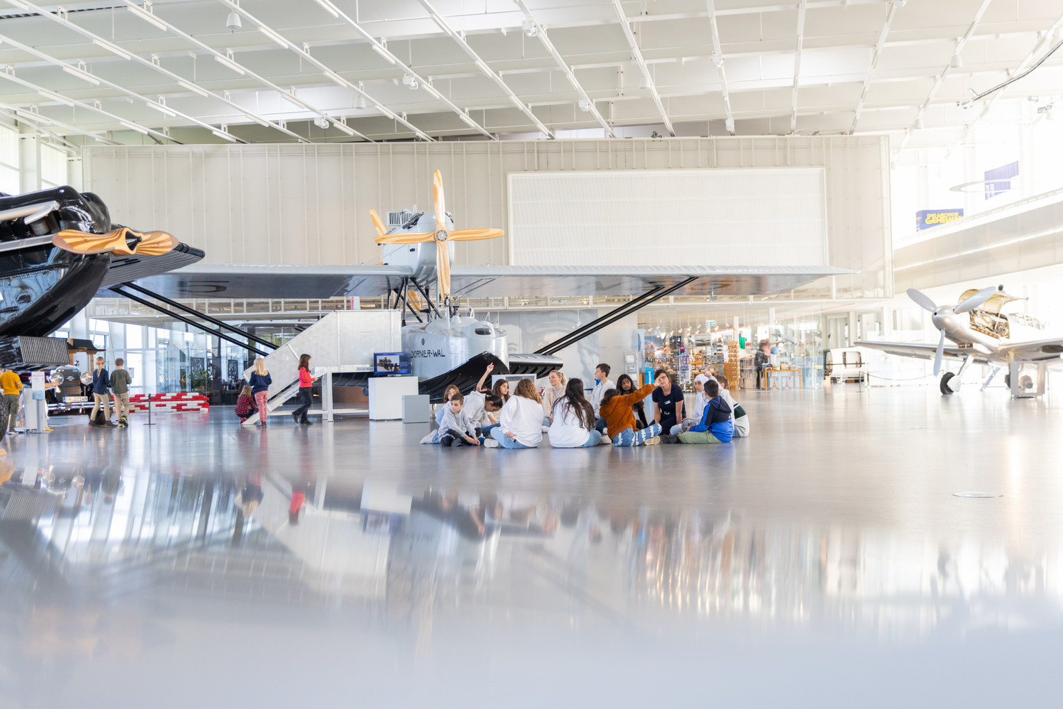 Schulklasse im Hangar Der Hangar mit einer Schulklasse im Hintergrund.
